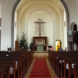 Blick zum Altar einer Kirche mit Christuskreuz.