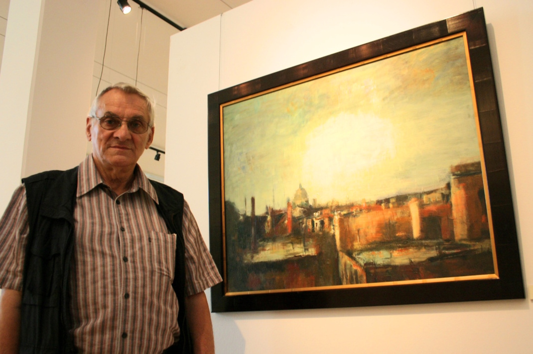 Älterer Mann neben Gemälde.