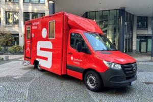 Sprinter-Fahrzeug in rot mit Logo der Sparkasse.